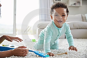 Mixed race mum and toddler son playing at home, close up