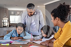 Mixed race parents helping children in homework at home