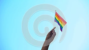 Mixed-race person hand holding flag of lgbtiq minority flag, pride, activism photo