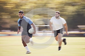 Mixed race rugby player running away from an opponent while attempting to score a try during a rugby match outside on a