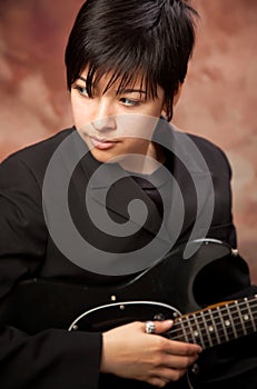 Mixed Race Teen Girl Poses with Electric Guitar