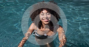 Mixed race woman enjoying her time in a pool