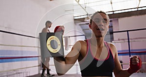 Mixed race woman happy to win in boxing gym