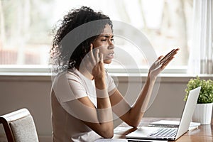 Mixed race woman having difficult conversation by mobile phone