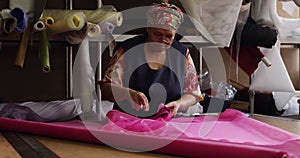 Mixed race woman working at a hat factory