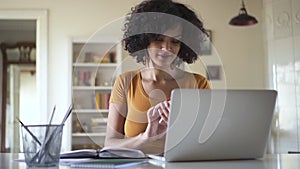 Mixed race woman works at laptop pick up the mobile phone and laughs hysterically Spbd.