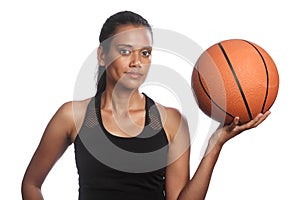 Mixed race womens basketball player holding ball