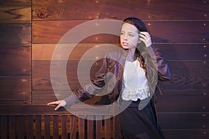 Mixed Race Young Adult Woman Portrait Against Wooden Wall