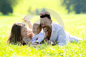 Mixed raced parents and Biracial baby outdoor portrait. Multiracial family. International family mom and dad with