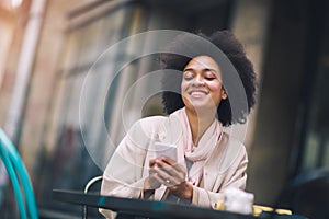 Mixed-raced woman using smartphone