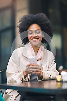 Mixed-raced woman using smartphone