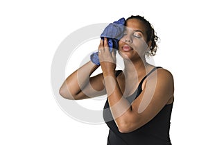 Mixed raced young woman  in black shirt after exercising drying face with blue towel isolated in white