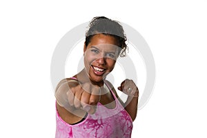 Mixed raced young woman  in pink shirt exercising by making punches isolated in white