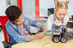 Mixed Racial group of School kids sitting at class with diy robot, stem education concept.