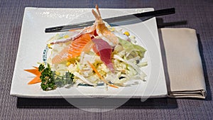 Mixed raw fish fillets on salad, fusion cousine