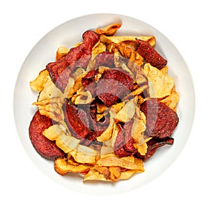 Mixed root vegetable crisps, sliced and fried root veg, in a white bowl
