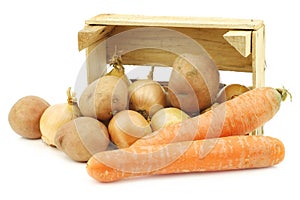 Mixed root vegetables for making `hutspot` in a wooden crate