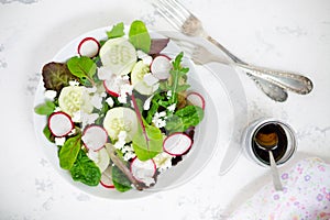 Mixed salad with baby leaves, radish, cucumber and feta cheese