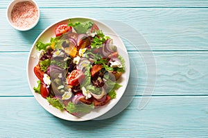 Mixed salad leaves, cherry tomatoes and red onions fresh salad