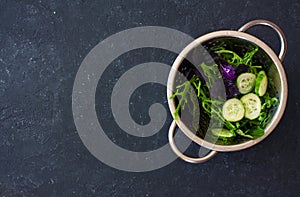 Mixed salad leaves lettuce, frisee, arugula, basil and cucumber