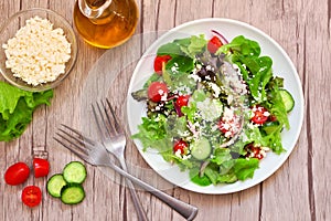 Mixed salad top view table scene against a wood background