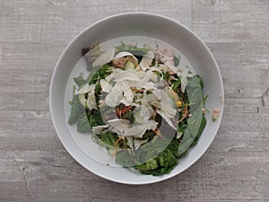 Mixed salad topped with shavings of Parmesan cheese