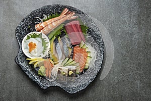 mixed sashimi plate in japanese restaurant on grey background