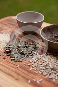 Mixed seeds on wooden background