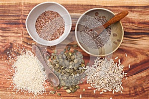 Mixed seeds on wooden background