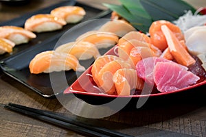 Mixed sliced fish sashimi on ice in white bowl. Sashimi Salmon Tuna Hamachi set, raw fish, japanese food in Asian restuarant
