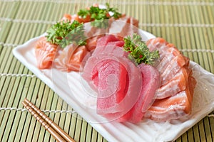 Mixed sliced fish sashimi on ice in white plate. Sashimi Salmon