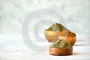 Mixed spice zaatar or zatar in wooden bowls, Various type of zaatar blend. Close up with copy space