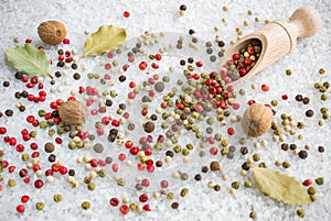 Mixed spices for cooking. Salt, bay leaves, nutmeg and color pepper.