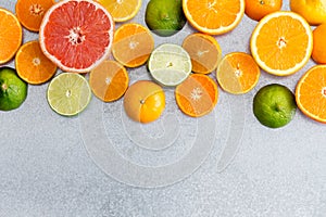 Mixed still life border of fresh cut citrus fruit