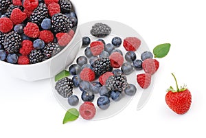 Mixed summer berries in white bowl.