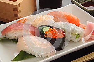 Mixed Sushi Platter on white plate with Sake, Japanese Food photo