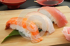Mixed Sushi Platter on wooden plate with Sake, Japanese Food photo