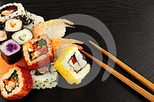 Mixed Sushi Rolls On A Slate Background