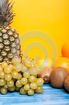 Mixed tasty fruit composition set on yellow background