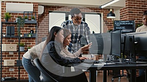 Mixed team of software engineers brainstorming ideas for new cloud computing user interface