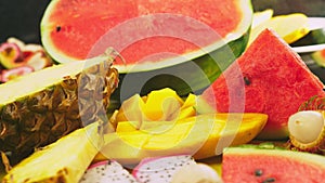 Mixed tropical fruits, closeup. fresh fruit sliced. background.