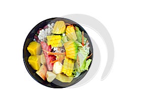 Mixed vegetable and fruit salad in black bowl