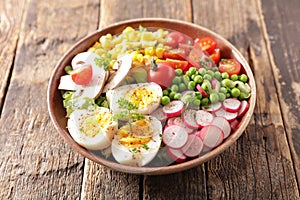 mixed vegetable salad with egg, radish, tomato and pea