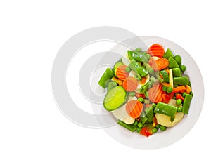 Mixed vegetables on a plate. top view. isolated