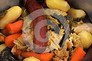 Mixed vegetables with a sausage close-up