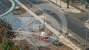 Mixer machine at concrete works for road construction with many workers timelapse