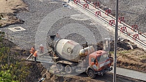 Mixer machine at concrete works for road construction with many workers timelapse