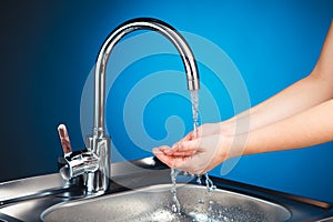 Mixer tap with water and washing hands