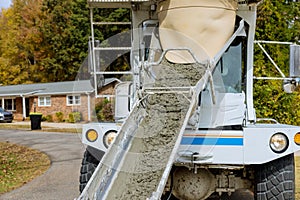 A mixer truck is used for the pouring of wet cement concrete in the construction area of a construction site