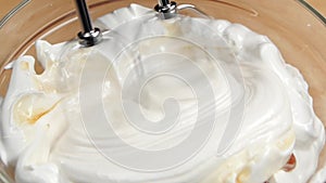 Mixer whip cream with syrup or liquid honey, slow motion